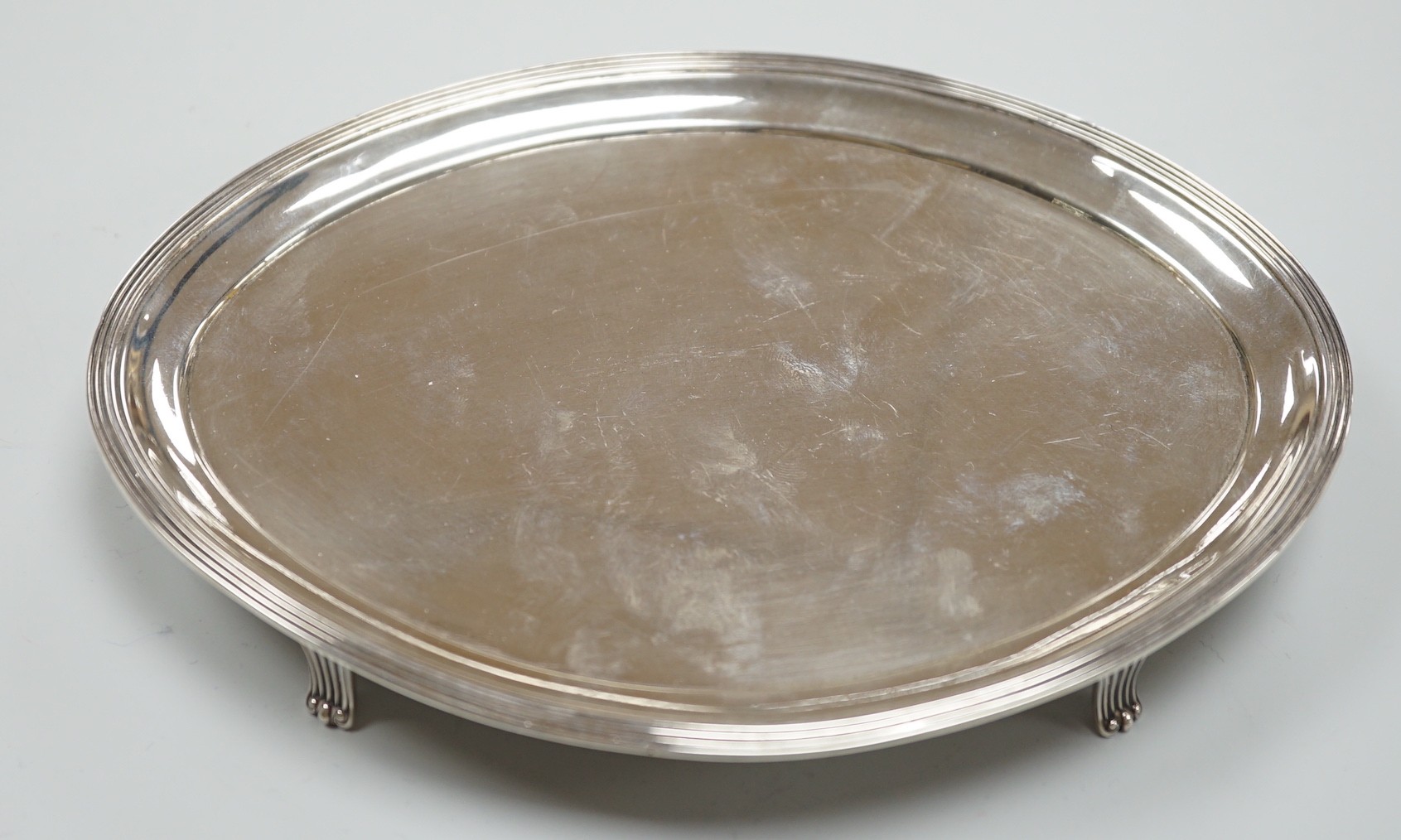 A George III silver oval teapot stand, by Peter, Ann & William Bateman, London, 1802, 18cm, 4.8oz, with reeded border, on four reeded feet.